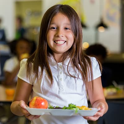 Niña con bandeja de cafetería